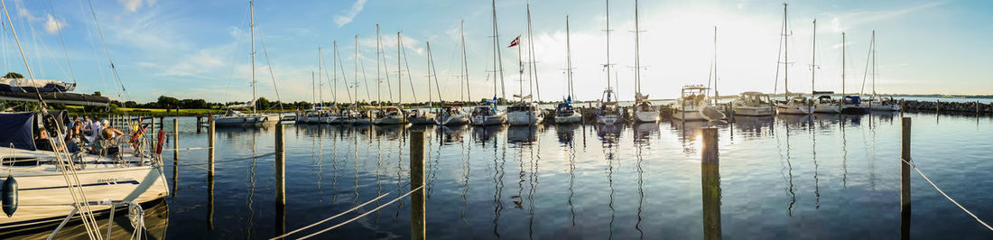 Sailboats in sea against sky