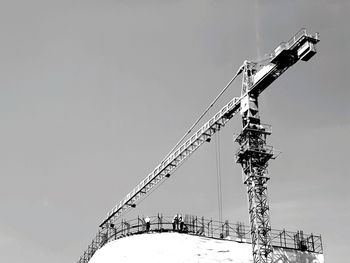 Low angle view of crane against clear sky