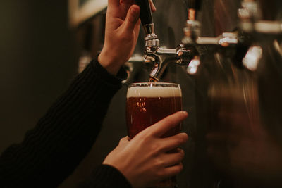 Female hands pouring beer