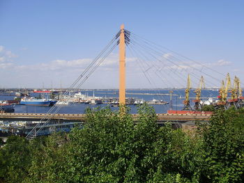 Ship moored at harbor against sky in city