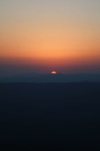 Scenic view of silhouette landscape against romantic sky at sunset