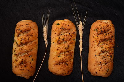 High angle view of bread on table against black background