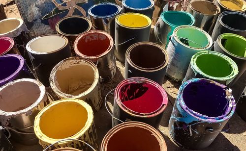 High angle view of multi colored paint cans