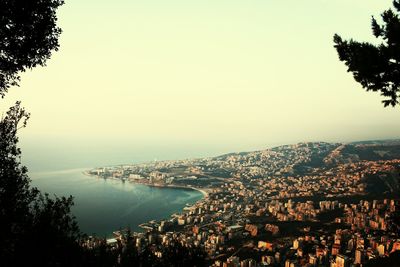 High angle view of townscape along calm blue sea