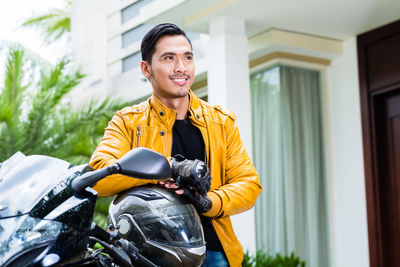 Portrait of smiling young man riding motorcycle