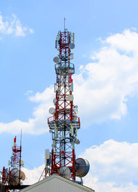 Cell tower with antenna against blue sky