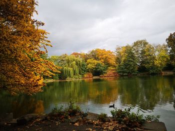 Scenic view of lake by trees against sky during autumn