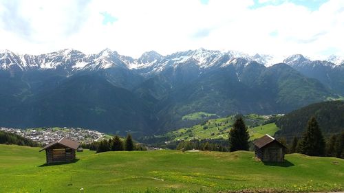 Scenic view of field and mountains against sky