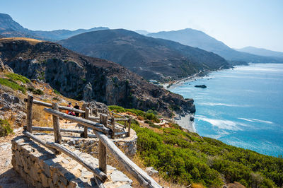 Scenic view of sea and mountains against sky