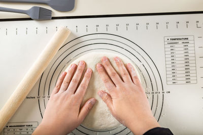 Cropped image of woman using laptop