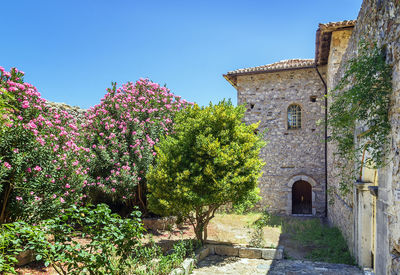 Low angle view of old building against clear blue sky