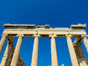 Low angle view of historical building against blue sky