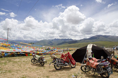 Motorcycles against mountain range and tibetan flags