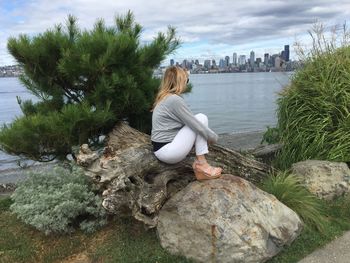 Rear view of woman sitting in park