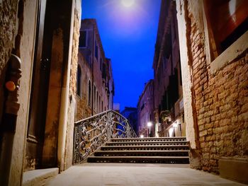 Low angle view of illuminated buildings against sky at night