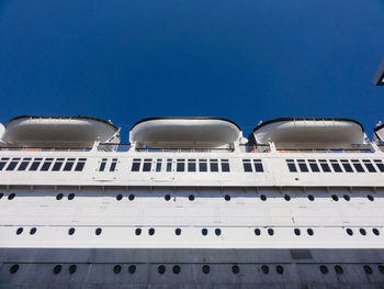 Low angle view of ship against clear blue sky