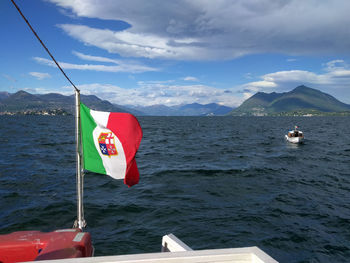 Boats in sea with mountain range in background