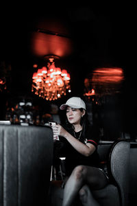 Portrait of young woman sitting on stage