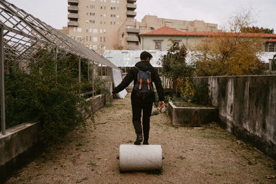 Full length of man standing by building in city