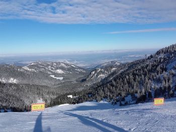 Scenic view of snow covered mountains against sky