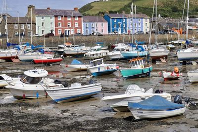 Boats moored at harbor in city