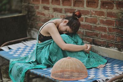 Young woman resting on bed