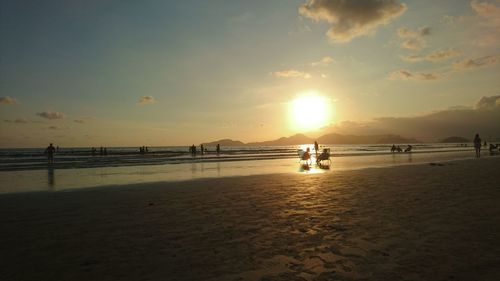 Scenic view of beach against sky during sunset