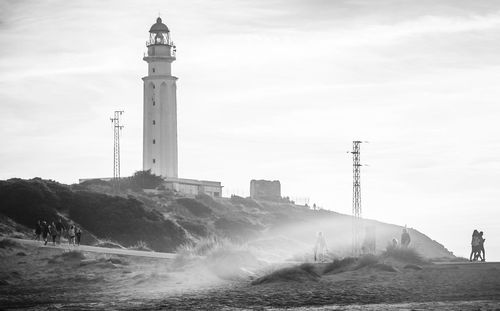 Tower in city against sky