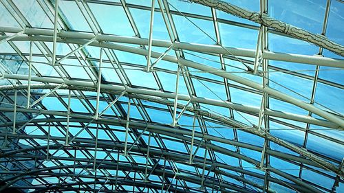 Low angle view of modern building against blue sky