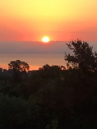 Scenic view of silhouette trees against sky during sunset