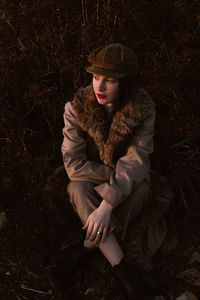 High angle view of young woman relaxing on field