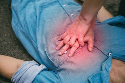 Midsection of couple sitting outdoors