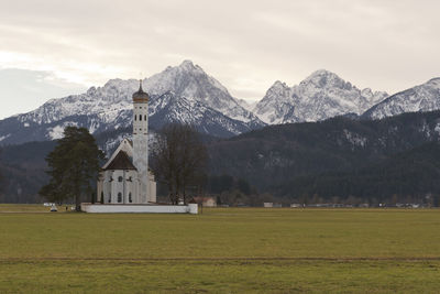 Scenic view of field and mountains against sky