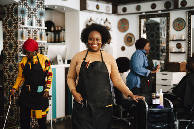 Portrait of confident female barber in hair salon