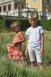 Portrait of smiling girl standing against plants