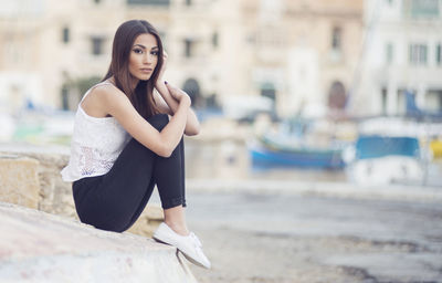 Portrait of young woman in city