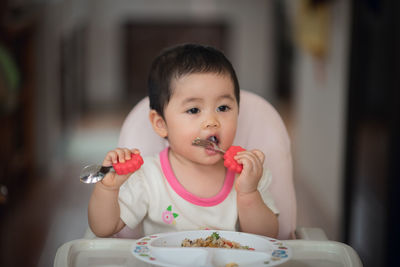 Portrait of cute boy eating food