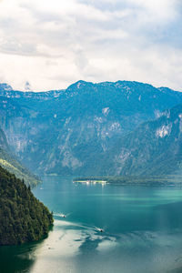 Scenic view of lake by mountains against sky