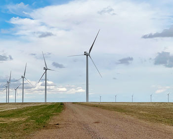 Windmill on field against sky