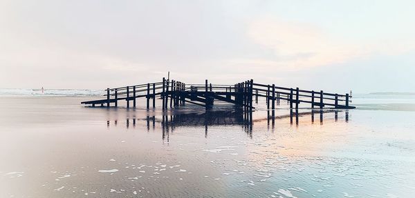 Pier on sea against sky