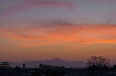 Silhouette buildings against sky during sunset