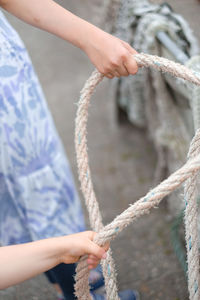 Midsection of man holding rope