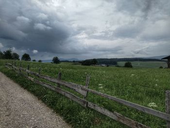 Scenic view of field against cloudy sky