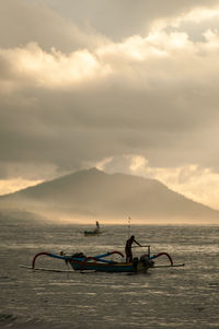 Scenic view of sea against cloudy sky