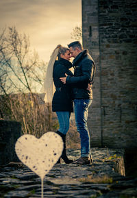 Rear view of couple standing on rock