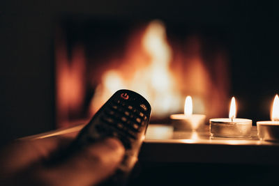 Tv remote control on the background of candles
