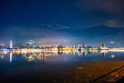 The city of lecco, with lakeside promenade and buildings, photographed in the evening in winter.