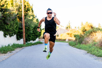 Full length of man running on road