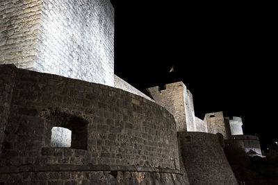 Low angle view of historic building against sky at night