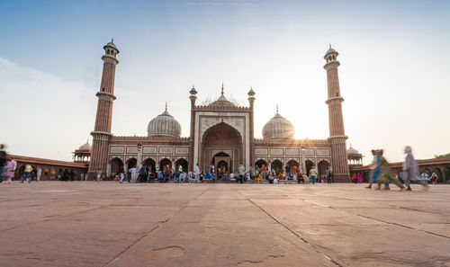 People by delhi jama masjid mosque against sky